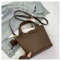 Dark brown leather bucket bag with flower charm and adjustable shoulder strap - Coffee