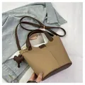 Khaki bucket bag with brown handles, shoulder strap and a leather elephant charm - Khaki