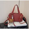 Retro rust red lychee texture handbag with cute brown plush bear charm and strap - Burgundy