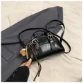 Glossy black vintage hobo bag with silver buckles and a cute bear charm accessory - Black With Pendant