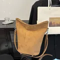 Brown faux suede leopard print bucket bag with silver metal hardware and slim shoulder strap - Brown
