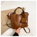 Chic brown leather tote bag with matching mini bag charm and adjustable strap - Brown