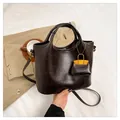 Dark brown faux leather handbag with yellow mini bag charm and shoulder strap - Dark Brown