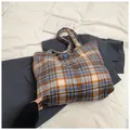 Blue and brown plaid flannel tote bag featuring a blue heart emblem and spacious interior - Blue Plaid