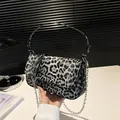 Fashionable leopard print baguette bag with silver chain strap on a modern background - Black Leopard