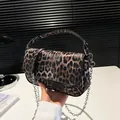Chic leopard print flap bag with silver chain strap and top handle in hand - Coffee Leopard