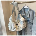 Light blue large capacity nylon crossbody bag with drawstring design and plush pendant - Off White