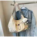 Beige nylon crossbody bag with adjustable strap and plush cloud pendant accessory - Khaki