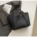 Black pebbled leather tote bag with elegant silk scarf wrap and gold bottom rivets - Black