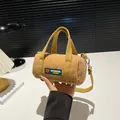 Yellow corduroy cylinder handbag for women featuring a stylish shoulder strap and hand carry - Khaki