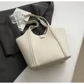 Creamy beige pebbled leather tote bag with silk scarf detail and golden metal feet - Off White