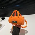 Orange corduroy barrel handbag with green patch and detachable crossbody strap - Orange