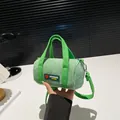 Light green corduroy cylinder crossbody bag with fabric handles and fashion label - Green