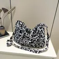 Large black and white leopard print tote bag with woven straps and matching shoulder belt - Black