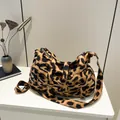 Vintage leopard print woven tote bag with wide strap in a minimalist setting - Brown