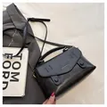 Detail of black PU leather bag showing vintage bronze hardware and adjustable strap - Coffee