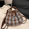 Blue and brown plaid wool backpack with leather trim and decorative toggle closure - Blue Plaid