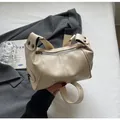 Chic cream white cylindrical underarm bag with silver hardware and rivet details - Off White
