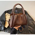 Vintage dark brown leather crossbody tote bag with top handles and logo embossing - Coffee
