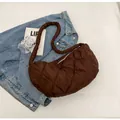 Brown quilted crossbody dumpling bag with soft padded texture and top zipper closure - Brown
