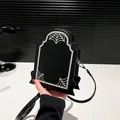 Quirky tombstone-shaped crossbody bag in black with white spider web and Gothic text - Black