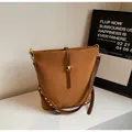 Vintage brown suede bucket bag with gold hardware and rivet details for women - Brown