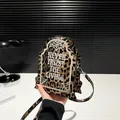 Gothic tombstone-shaped crossbody bag featuring leopard print and 'Never Trust The Living' text - Leopard Print