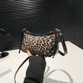 Fashionable leopard print shoulder bag with bow detail and black patent leather trim - Black