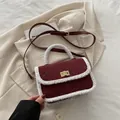 Chic burgundy quilted crossbody bag with white plush trim and golden twist lock detail - Red