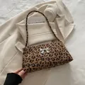 Leopard print underarm bag with a silver metal bow accent and slim shoulder strap - Khaki