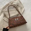 French vintage leopard print underarm bag featuring a silver metal bow accent - Red Brown