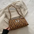 Fashionable leopard print underarm bag with a silver bow buckle on beige suit jacket - Yellow Brown