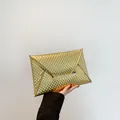Elegant gold envelope clutch with textured 3D scales and metallic buckle closure - Gold