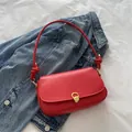 Minimalist red leather shoulder bag for women with golden metal lock and knotted strap - Red