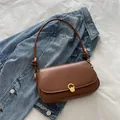 Minimalist brown leather underarm bag with unique rope strap and gold buckle - Brown