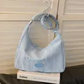 Light blue pleated fabric crossbody bag with adjustable strap and golden zipper detail - Blue