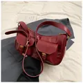 Detail view of burgundy faux leather underarm bag with functional double front pockets - Red