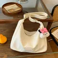 Creamy white hobo shoulder bag in glossy patent leather with plush charm decoration - Beige with Pendant
