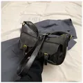 Retro black shoulder bag with dual front pockets and elegant gold metal hardware - Black