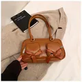 Brown leather shoulder bag with ribbon bows and double pockets on beige coat - Brown