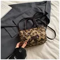 Close-up of leopard print faux fur texture and brand label on a stylish crossbody tote bag - Coffee Leopard