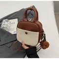 Petit sac à dos en cuir bicolore marron et beige avec charm ours en peluche chic - Marron avec Pendentif