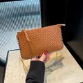 Brown woven crossbody bag with silver studs and chain strap in sleek Intrecciato style - Brown