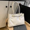 Chic cream-colored large capacity tote bag in soft leather with gold metal buckle detail - White