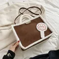 Brown and white faux shearling tote bag with shoulder strap and plush brand patch - Brown