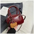 Retro burgundy Boston handbag in glossy leather with a cute plush bear charm and strap - Burgundy