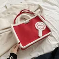 Red suede tote bag with white faux shearling trim and stylish red handles - Red