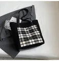 Black plush tote bag with black and white checkered pocket and faux leather straps - Black
