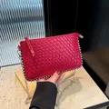 Red woven crossbody bag with metallic silver studs and thin chain strap for women - Red
