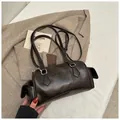 Sac cylindrique marron foncé avec boucles argentées et poches sur fond de tissu blanc - Café sans pendentif